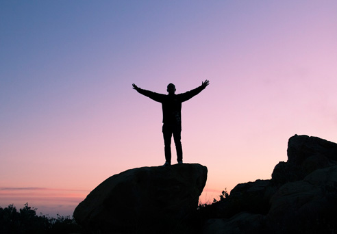 Man standing on rocks, freedom of time