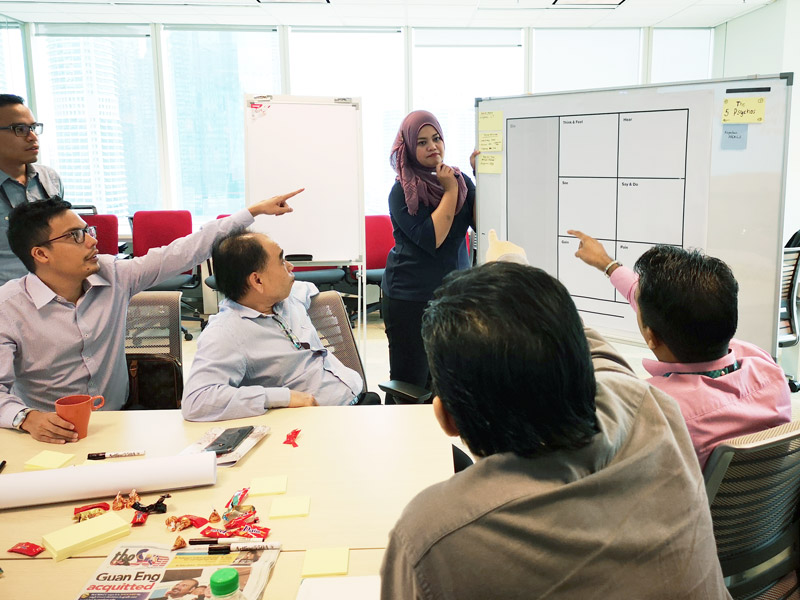 Participant pointing at sticky note